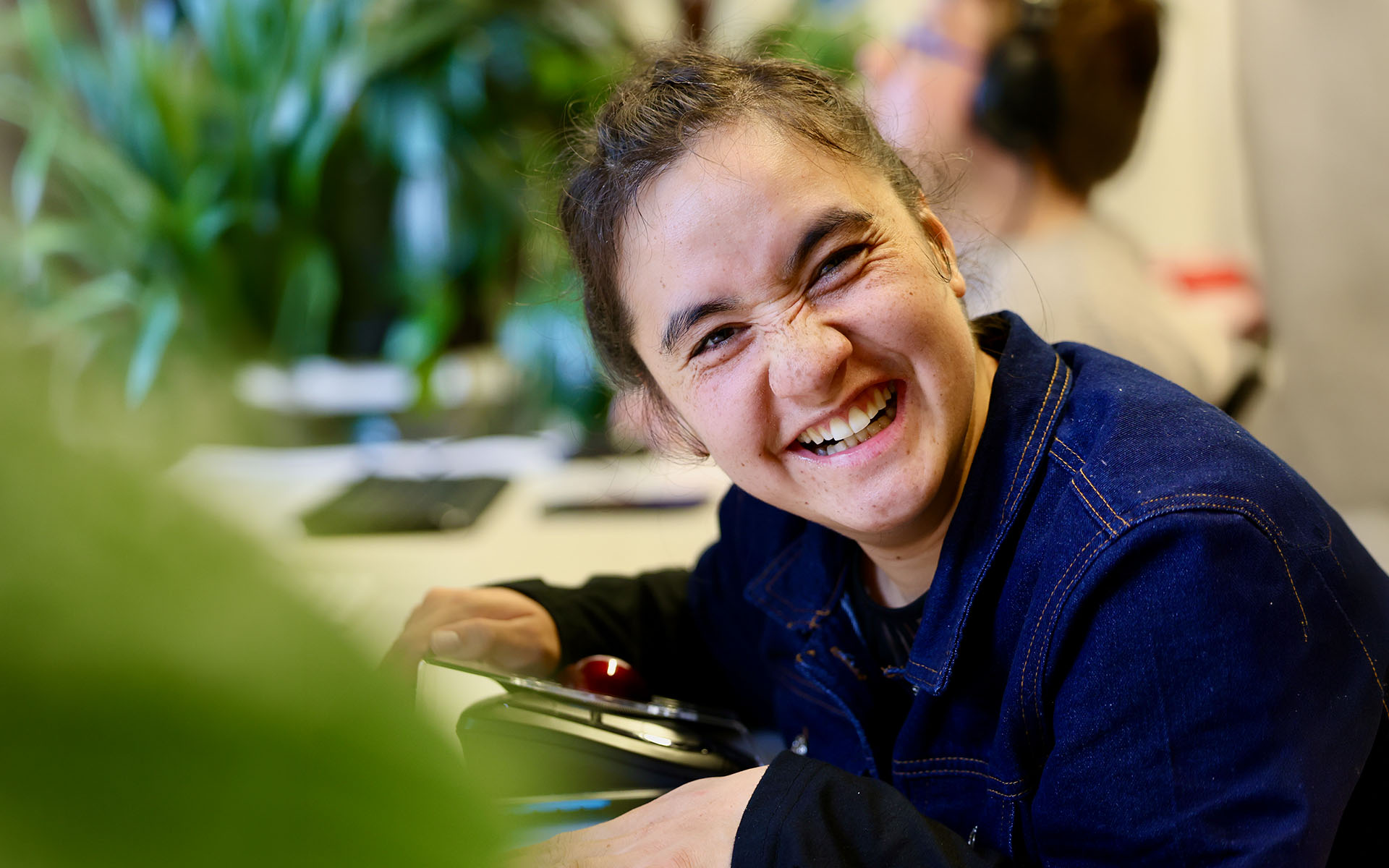 A Wallara participant smiling while taking part in a computer activity.