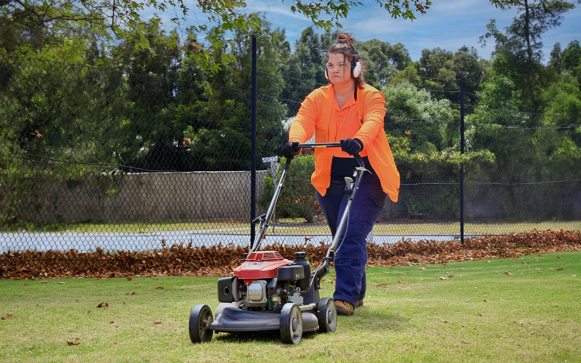 A Wallara participant operates a lawn mower while working in the Land Management Services team.