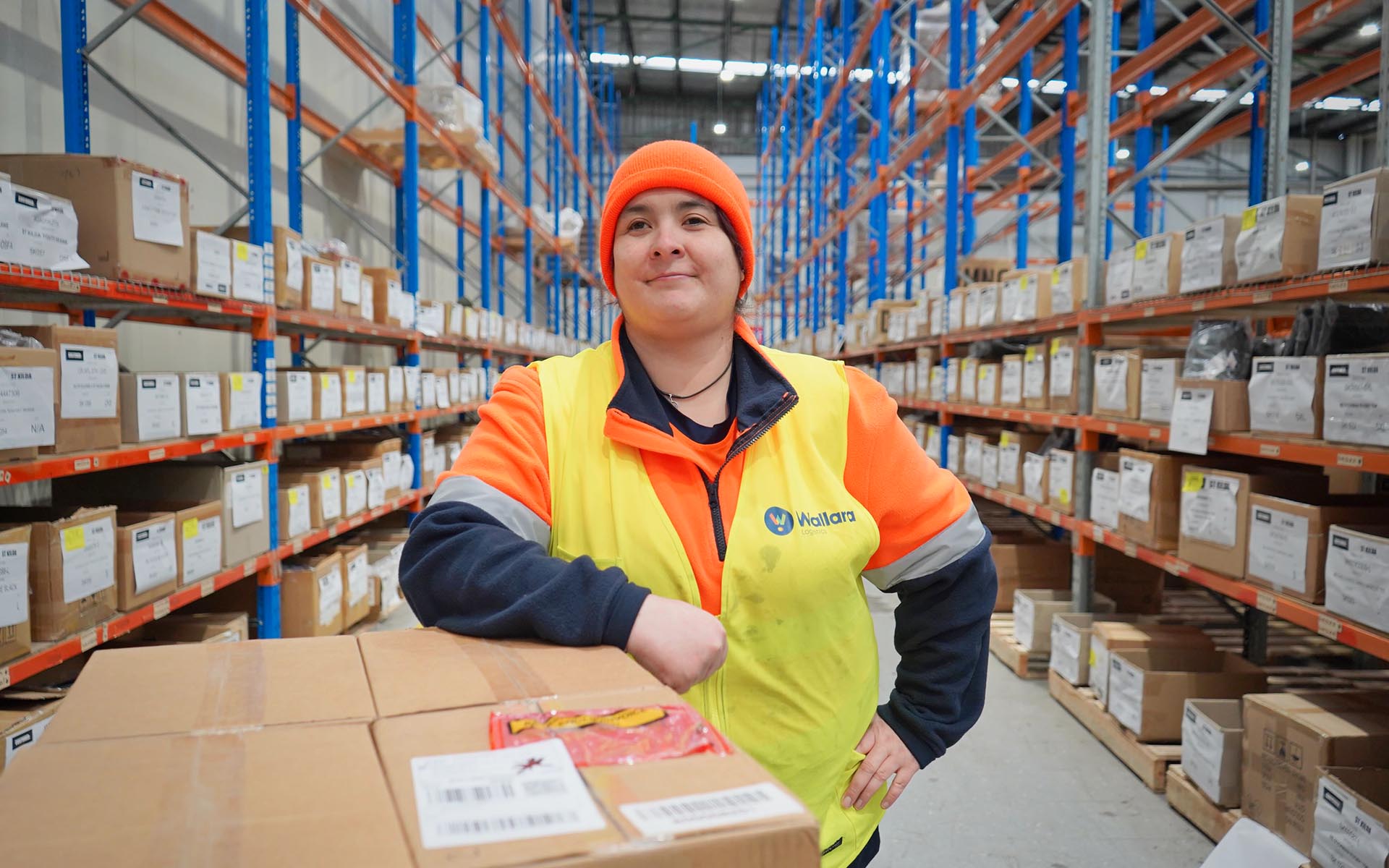 A Wallara participant working in a warehouse environment.