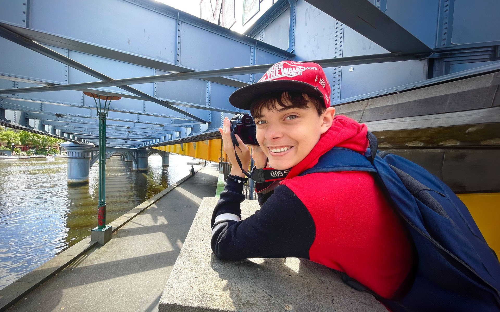 A Wallara participant taking photographs outdoors near the water.