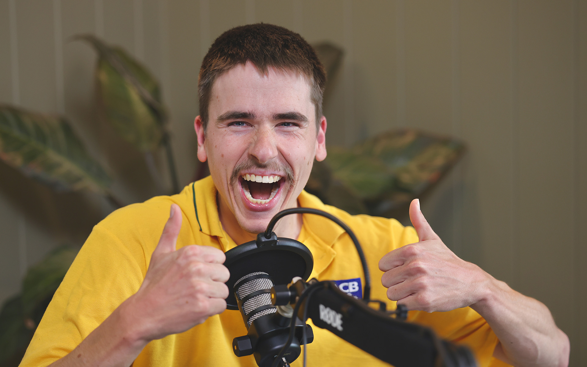 A Wallara participant speaking into a microphone in a media studio.