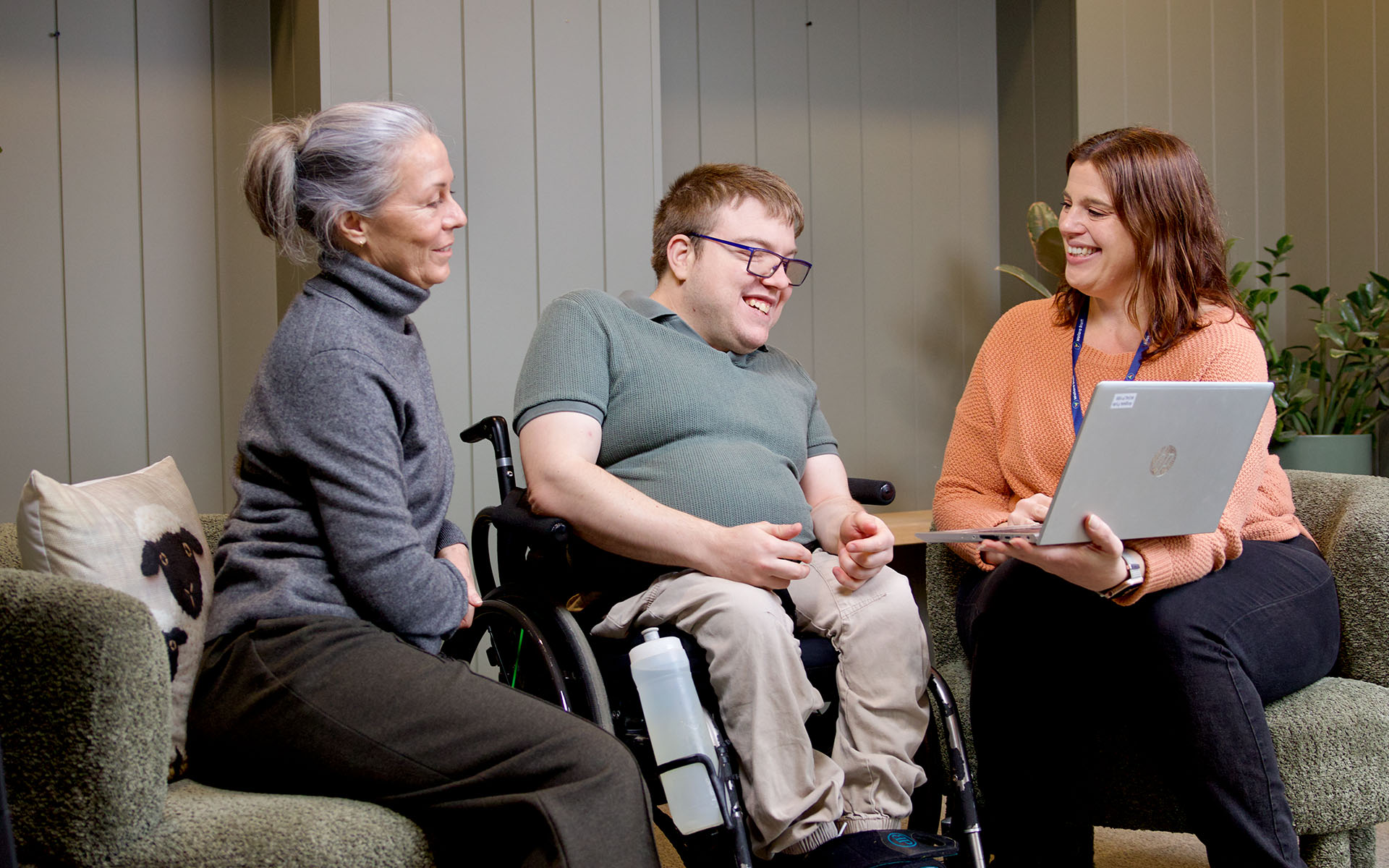 Wallara staff members meeting with a participant in a support coordination setting.